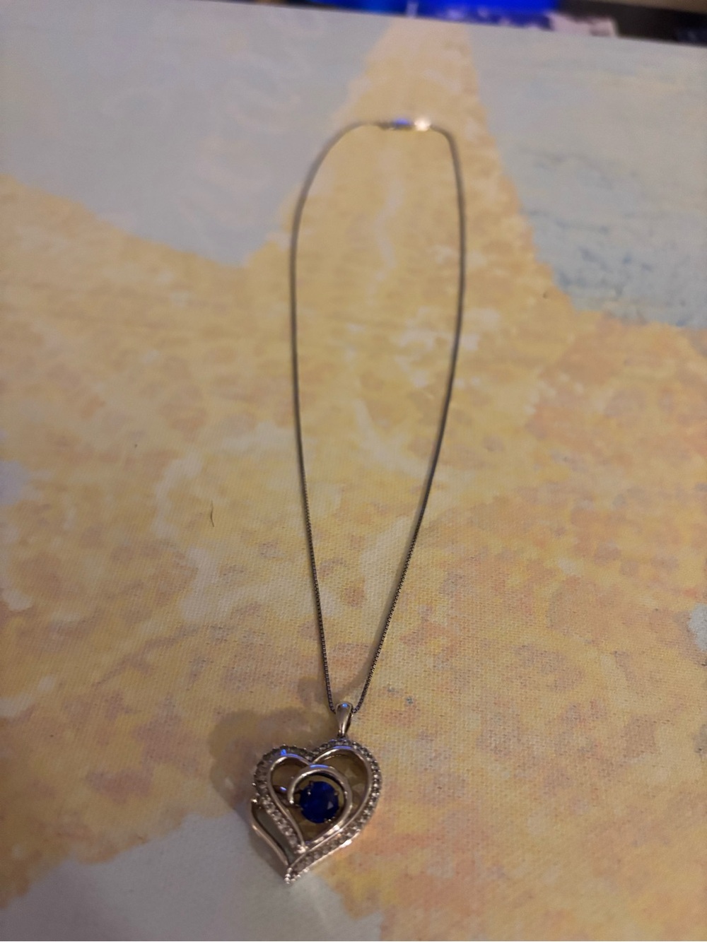This beautiful sterling silver heart shaped with blue stone that dangles. 22.00